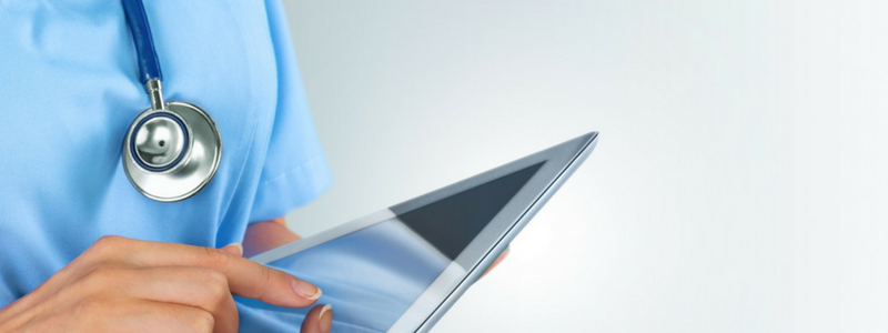 Clinician holding EHR tablet during selection and implementation process