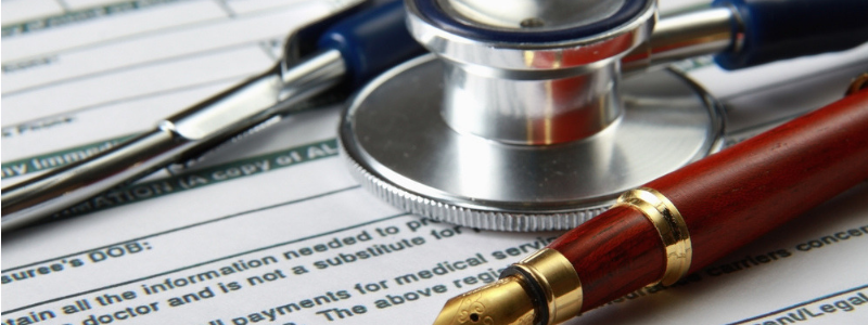 Stethoscope and pen in medical billing audit