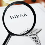 HIPAA healthcare document with magnifying glass