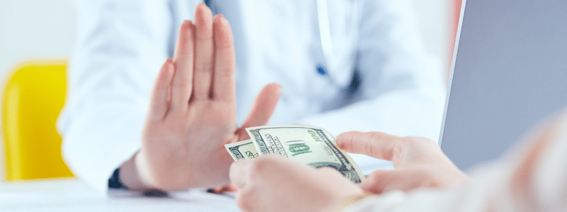 A doctor refusing money because of anti kickback law in healthcare.