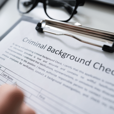 Criminal background check form on clipboard.
