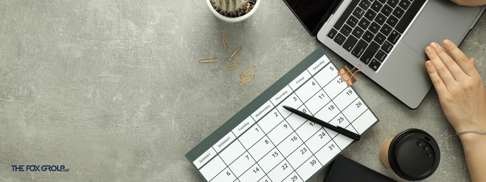 Desktop with calendar and computer signifying the preparation of a Healthcare Compliance Annual Work Plan.
